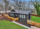 Charming home showcasing a new roof, dark siding, and a cozy wooden porch at 875 Center Hill Nw Ave, Atlanta, GA 30318