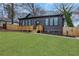 Charming home boasting dark siding, a welcoming porch, and a neatly manicured front yard at 875 Center Hill Nw Ave, Atlanta, GA 30318