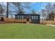 Inviting home with dark siding, large windows, and a charming wooden porch and green lawn at 875 Center Hill Nw Ave, Atlanta, GA 30318