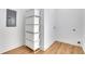 Laundry room with wood floors, a stack of white storage boxes, and white walls at 875 Center Hill Nw Ave, Atlanta, GA 30318