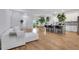 Open-concept living room flowing into dining & kitchen, featuring hardwood floors and a modern aesthetic at 875 Center Hill Nw Ave, Atlanta, GA 30318