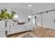 Bright main bedroom features hardwood floors, neutral walls, and sliding barn door to en-suite bathroom at 875 Center Hill Nw Ave, Atlanta, GA 30318