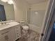 Bathroom with vanity, sink, mirror, toilet, and shower-tub combo at 1734 Victoria Nw Way, Kennesaw, GA 30152