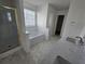 Bright bathroom featuring a shower, tub, and double sink vanity with solid surface countertops at 1734 Victoria Nw Way, Kennesaw, GA 30152