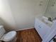 Cozy powder room featuring hardwood floors, white vanity, and a toilet at 1734 Victoria Nw Way, Kennesaw, GA 30152