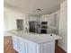 Modern kitchen with white cabinets, stainless steel appliances, and a breakfast bar with light countertops at 1734 Victoria Nw Way, Kennesaw, GA 30152