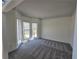 Bright living room featuring neutral-toned walls, plush carpeting, and a large bay window at 1734 Victoria Nw Way, Kennesaw, GA 30152