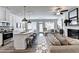 Open-concept living area with a kitchen island and stainless steel appliances is perfect for entertaining at 2704 Ne Almand Ln, Conyers, GA 30013