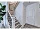 Hallway featuring staircase with modern railing and neutral color palette at 2704 Ne Almand Ln, Conyers, GA 30013