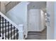 Hallway featuring staircase with modern railing and neutral color palette at 2704 Ne Almand Ln, Conyers, GA 30013