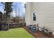 Well-maintained backyard featuring green grass, a wooden fence, and two efficient air conditioning units at 4126 Dream Catcher Dr, Woodstock, GA 30189