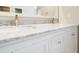 Bathroom vanity with marble countertop, double sink, and white cabinets at 4126 Dream Catcher Dr, Woodstock, GA 30189