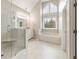 Bright Primary bath with soaking tub, glass enclosed shower and double sink vanity at 4126 Dream Catcher Dr, Woodstock, GA 30189