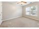 Bright bedroom featuring neutral carpet, ceiling fan and double window allowing ample natural light at 4126 Dream Catcher Dr, Woodstock, GA 30189