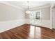 Bright dining room featuring wainscoting, hardwood floors, and a modern light fixture at 4126 Dream Catcher Dr, Woodstock, GA 30189