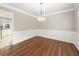 Dining room featuring wainscoting, hardwood floors, and a modern light fixture at 4126 Dream Catcher Dr, Woodstock, GA 30189