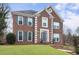 Charming brick home featuring a well-manicured lawn, gray shutters, and meticulous landscaping at 4126 Dream Catcher Dr, Woodstock, GA 30189