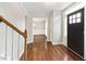 Foyer with hardwood floors, staircase, and entryway to the dining room at 4126 Dream Catcher Dr, Woodstock, GA 30189