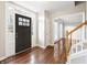Welcoming foyer with dark wood door, hardwood floors, and staircase at 4126 Dream Catcher Dr, Woodstock, GA 30189