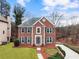 Well-manicured front yard, with driveway, that highlights the brick facade, and detailed trim at 4126 Dream Catcher Dr, Woodstock, GA 30189