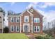 Charming brick home featuring symmetrical design, well-maintained lawn, and classic architectural details at 4126 Dream Catcher Dr, Woodstock, GA 30189