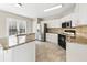 Bright kitchen features granite countertops, stainless steel appliances, and tiled flooring at 4126 Dream Catcher Dr, Woodstock, GA 30189