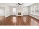Spacious living room with fireplace, hardwood floors, and natural light from large windows at 4126 Dream Catcher Dr, Woodstock, GA 30189