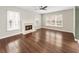 Bright living room boasts a fireplace, ceiling fan and hardwood floors at 4126 Dream Catcher Dr, Woodstock, GA 30189