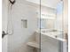 Beautifully tiled shower with glass enclosure and built-in bench at 4126 Dream Catcher Dr, Woodstock, GA 30189