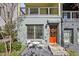 Charming home exterior with an orange front door and a cozy seating area on the front stoop at 765 Aerial Way, Atlanta, GA 30316