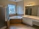 Elegant bathroom featuring a soaking tub, separate shower, and ample vanity space at 1272 Creekside Se Ter, Smyrna, GA 30082