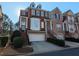 Attractive townhouse with brick facade, dormer windows, and attached garage at 1272 Creekside Se Ter, Smyrna, GA 30082