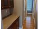 Hallway with wood floors, wainscoting, built-in cabinets with countertop, and access to bathroom at 1272 Creekside Se Ter, Smyrna, GA 30082
