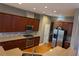 Modern kitchen with stainless steel appliances, wooden cabinets, and granite countertops at 1272 Creekside Se Ter, Smyrna, GA 30082