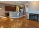 Open-concept living room and kitchen featuring hardwood floors and a gas fireplace at 1272 Creekside Se Ter, Smyrna, GA 30082
