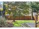 Spacious backyard with lush lawn, mature trees, and a wooden fence for privacy at 1280 N Morningside Ne Dr, Atlanta, GA 30306