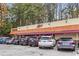 Alon's Bakery exterior with a red awning, multiple cars parked in front and signage at 1280 N Morningside Ne Dr, Atlanta, GA 30306