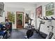 Bright home gym features multiple machines, rubber floors, a TV, and deck access at 1280 N Morningside Ne Dr, Atlanta, GA 30306