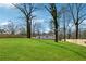 Wide shot of lush backyard with green grass, tall trees, and a wooden privacy fence at 3482 Atlanta St, Atlanta, GA 30337