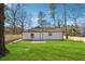 Exterior home view highlighting the vast backyard with lush green grass and privacy fence at 3482 Atlanta St, Atlanta, GA 30337