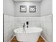 Modern bathroom with a freestanding tub, marble-like tile, and stylish decor creates a relaxing spa-like experience at 3482 Atlanta St, Atlanta, GA 30337