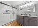 Modern bathroom with double vanity, granite countertops, walk-in shower, tile, and modern sliding glass door at 3482 Atlanta St, Atlanta, GA 30337