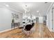 Open dining area with hardwood floors, modern chandelier, and seamless access to the well-lit kitchen at 3482 Atlanta St, Atlanta, GA 30337