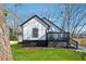 Side view of modern renovated home with a black and white trim, outdoor deck, and green lawn at 3482 Atlanta St, Atlanta, GA 30337