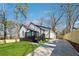 Modern renovated home with black and white trim, outdoor deck, and a concrete driveway at 3482 Atlanta St, Atlanta, GA 30337