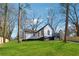 A lovely renovated home featuring black and white trim, outdoor deck, and a spacious green lawn at 3482 Atlanta St, Atlanta, GA 30337