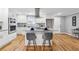 Bright kitchen features white cabinets, stainless steel appliances, and an island with seating at 3482 Atlanta St, Atlanta, GA 30337