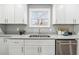 A stainless steel sink with granite countertops and white shaker cabinets at 3482 Atlanta St, Atlanta, GA 30337