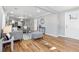 Bright living room featuring hardwood floors, contemporary gray furniture, and open layout to the kitchen at 3482 Atlanta St, Atlanta, GA 30337