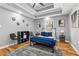 Spacious main bedroom featuring a tray ceiling, hardwood floors, fan, and stylish decor at 3482 Atlanta St, Atlanta, GA 30337